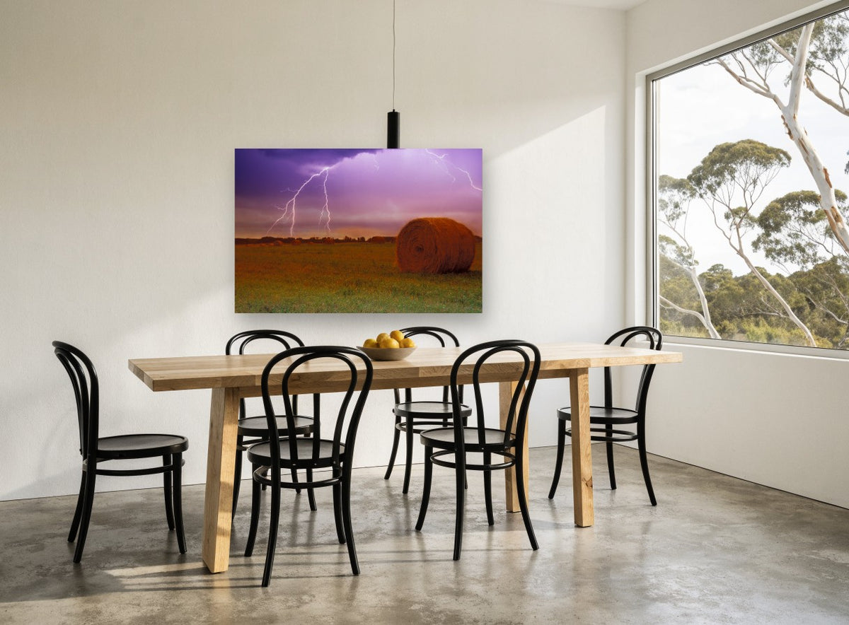 Lightning Over Hay Bales landscape canvas print on the wall of a dining room