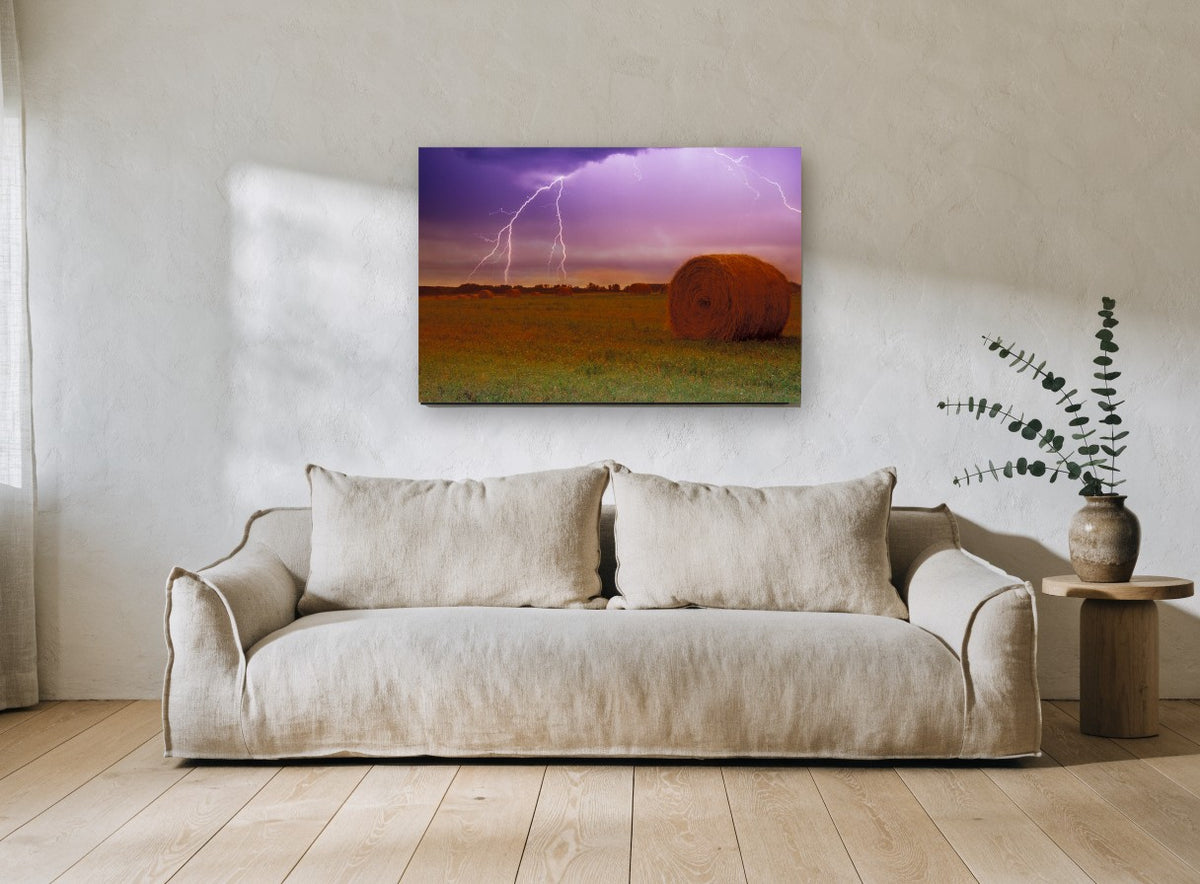 Lightning Over Hay Bales landscape canvas print on the wall of a living room