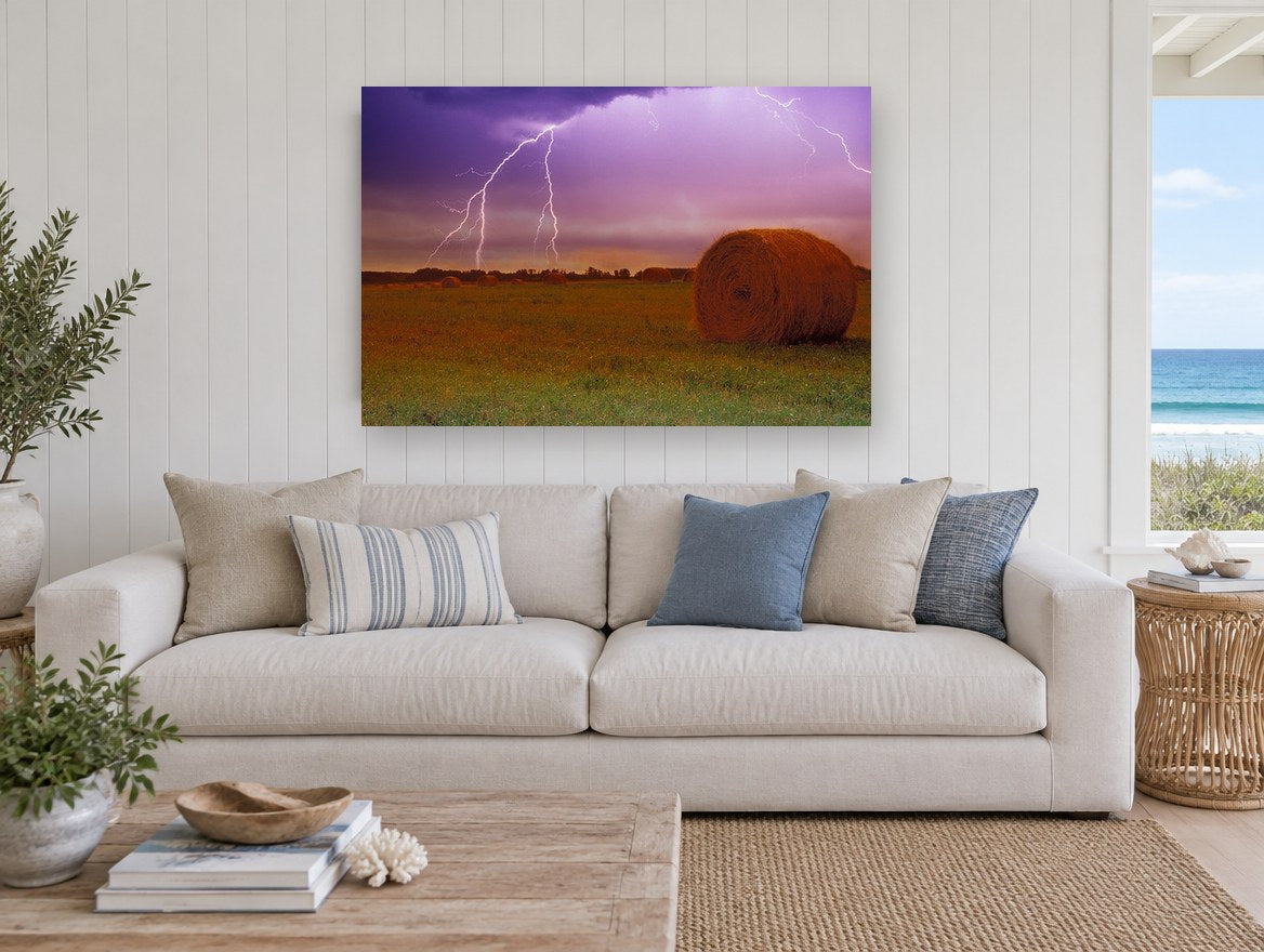 Lightning Over Hay Bales landscape canvas print on the wall of a beach house living room