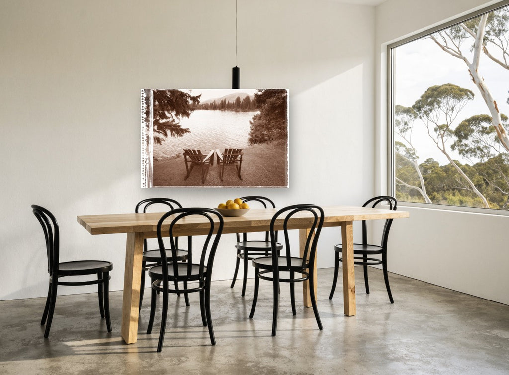 Two Chairs Lakeside landscape canvas print on the wall of a dining room