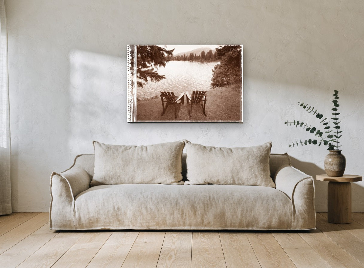 Two Chairs Lakeside landscape canvas print on the wall of a living room