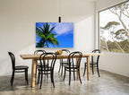 Palm Against Blue landscape canvas print on the wall of a dining room