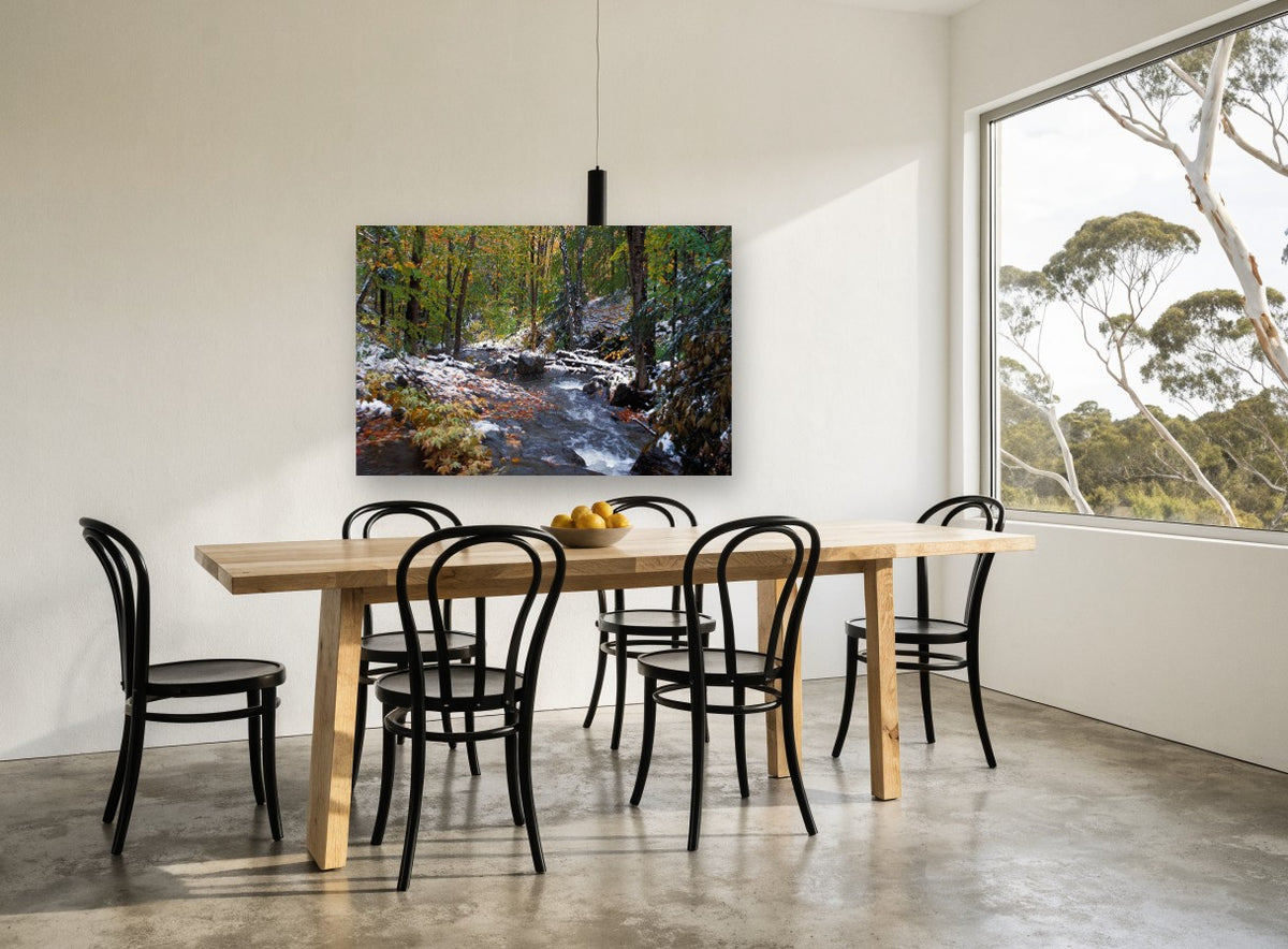 First Snow Creek landscape canvas print on the wall of a dining room