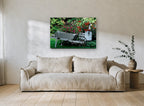 Garden Wheelbarrow Planter floral canvas print on the wall of a living room