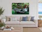 Garden Wheelbarrow Planter floral canvas print on the wall of a beach house living room