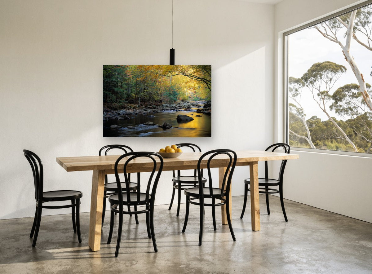 Golden Autumn Creek landscape canvas print on the wall of a dining room