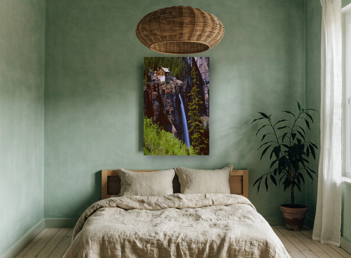 Cliffside Cabin Falls landscape canvas print on the wall of a bedroom