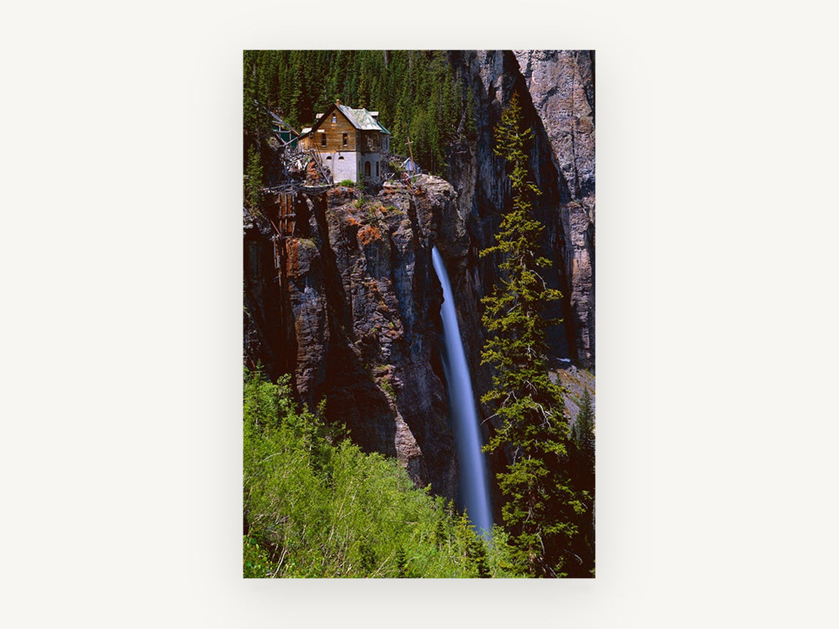 Cliffside Cabin Falls, waterfall beside cliff cabin photograph, landscape canvas wall art print, front view