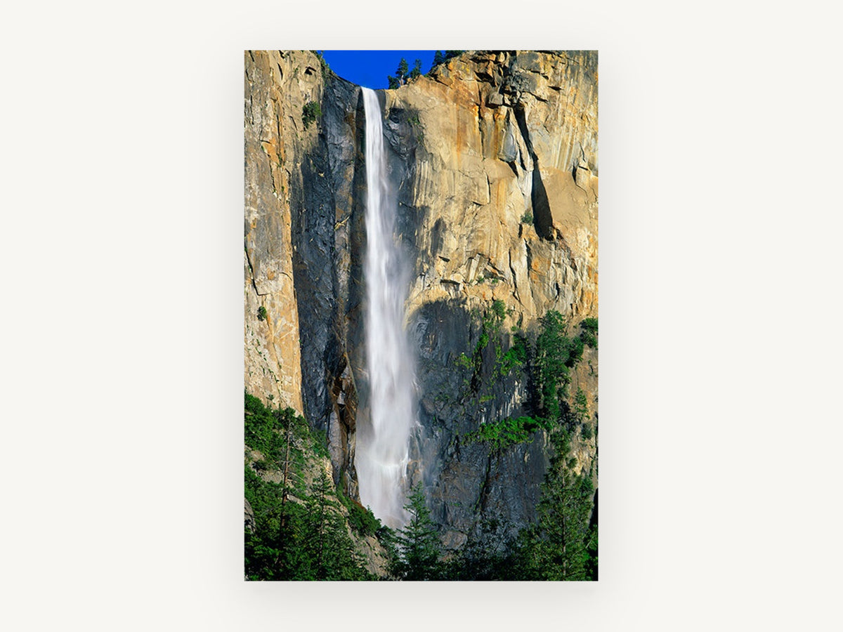 Sunlit Cliff Cascade, tall waterfall granite cliff photograph, landscape canvas wall art print, front view