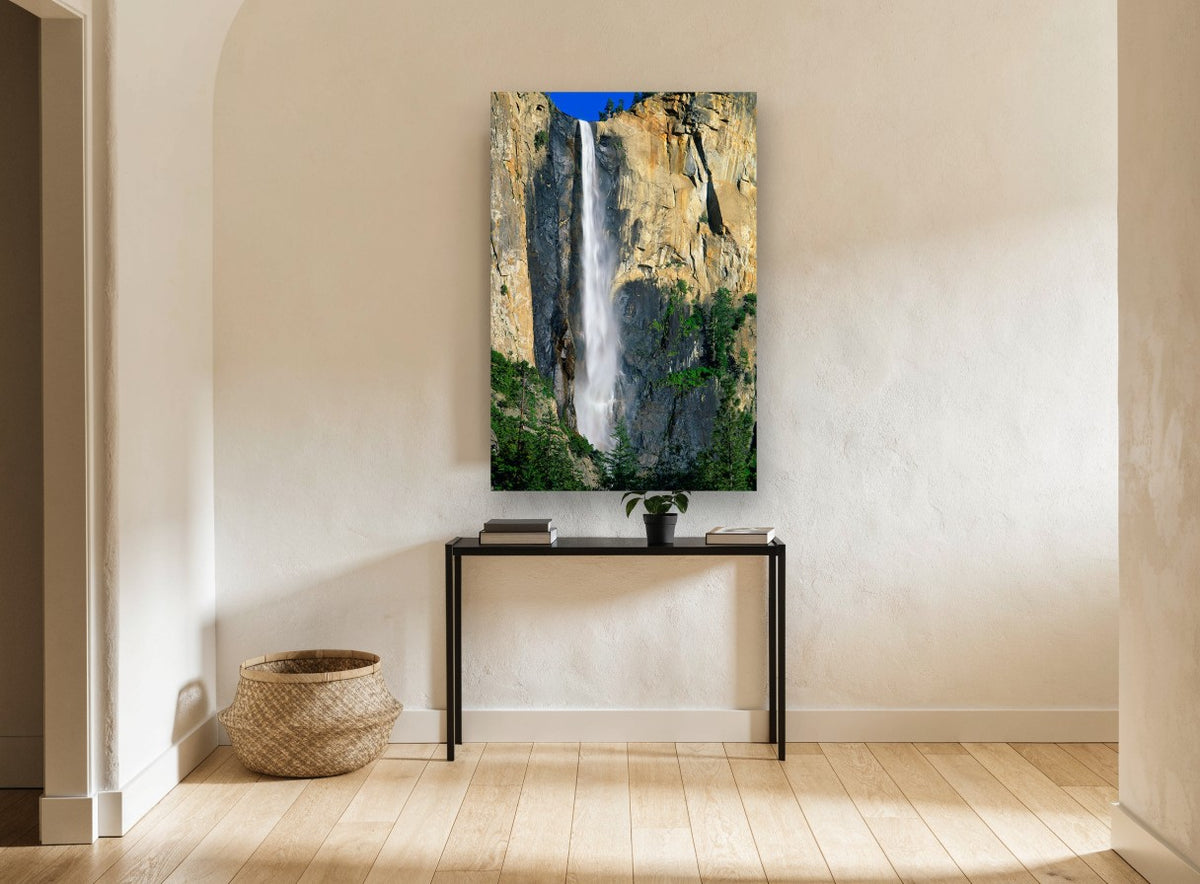 Sunlit Cliff Cascade landscape canvas print on the wall of a hallway