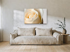 Cream Rose Unfurling floral canvas print on the wall of a living room