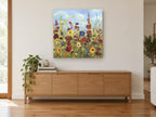 Meadow Under Blue Sky floral canvas print on the wall of a living room above a sideboard