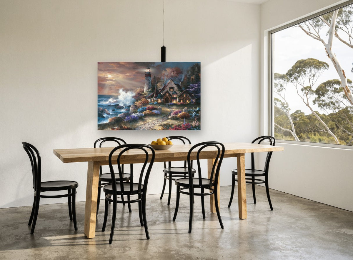 Lighthouse Cottage Glow coastal canvas print on the wall of a dining room
