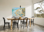 Two Chairs at the Shoreline coastal canvas print on the wall of a dining room