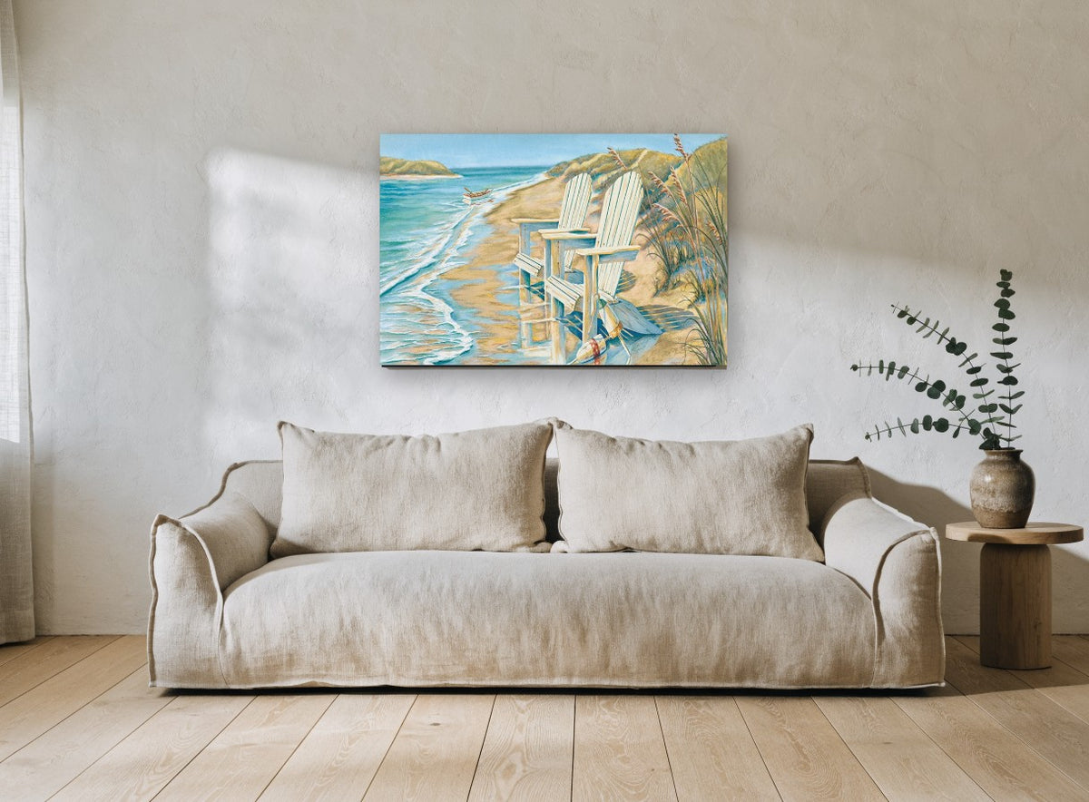 Two Chairs at the Shoreline coastal canvas print on the wall of a living room