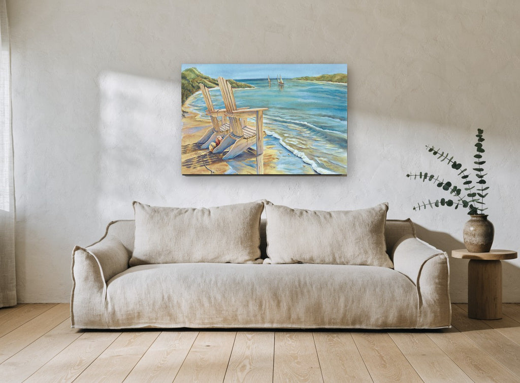 Two Chairs at the Shore coastal canvas print on the wall of a living room