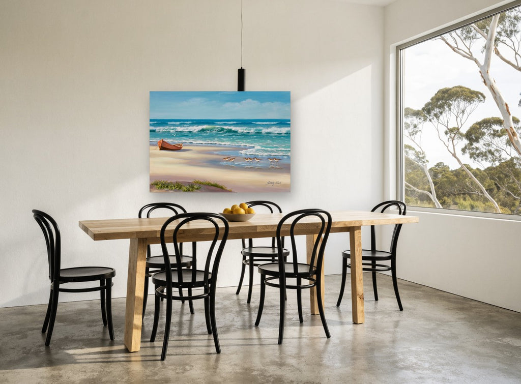 Sandpipers and Beached Boat coastal canvas print on the wall of a dining room