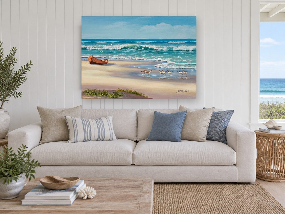 Sandpipers and Beached Boat coastal canvas print on the wall of a beach house living room