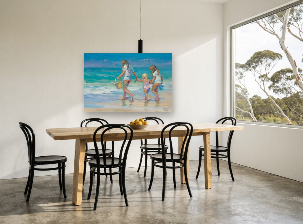 Three Girls at Water's Edge coastal canvas print on the wall of a dining room