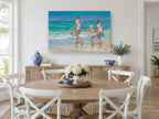 Three Girls at Water's Edge coastal canvas print on the wall of a Hamptons dining room