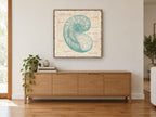 Teal Nautilus Shell Study coastal canvas print on the wall of a living room above a sideboard