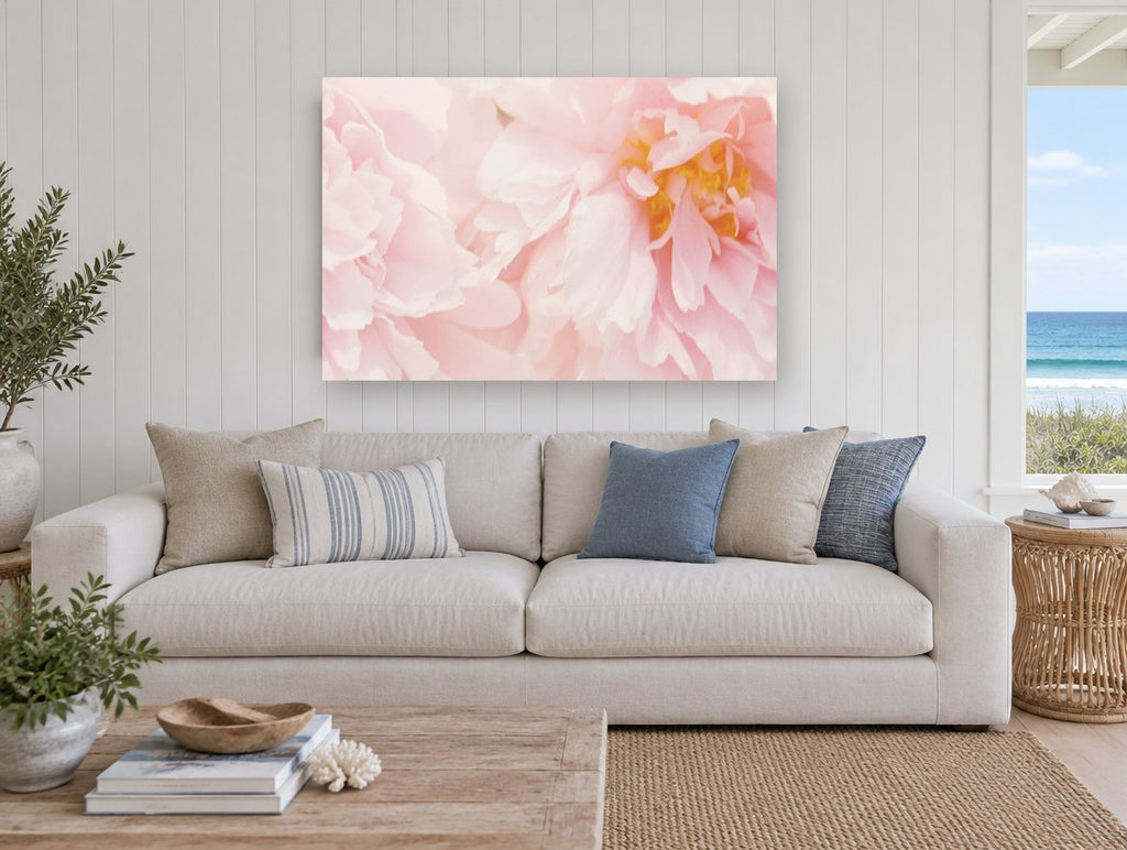 Soft Blush Peonies floral canvas print on the wall of a beach house living room
