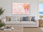 Soft Blush Peonies floral canvas print on the wall of a beach house living room