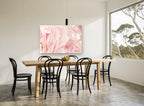 Soft Pink Peony Layers floral canvas print on the wall of a dining room
