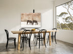 Grazing in Winter Snow vintage canvas print on the wall of a dining room