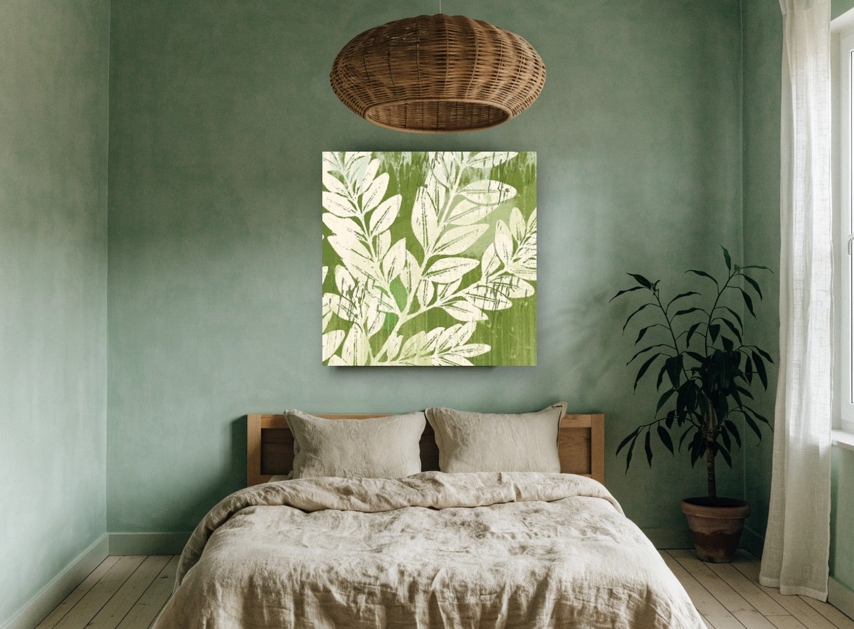 Sage Leaf Silhouettes floral canvas print on the wall of a bedroom