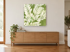 Sage Leaf Silhouettes floral canvas print on the wall of a living room above a sideboard