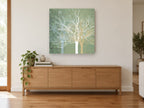 Sage Winter Branches landscape canvas print on the wall of a living room above a sideboard