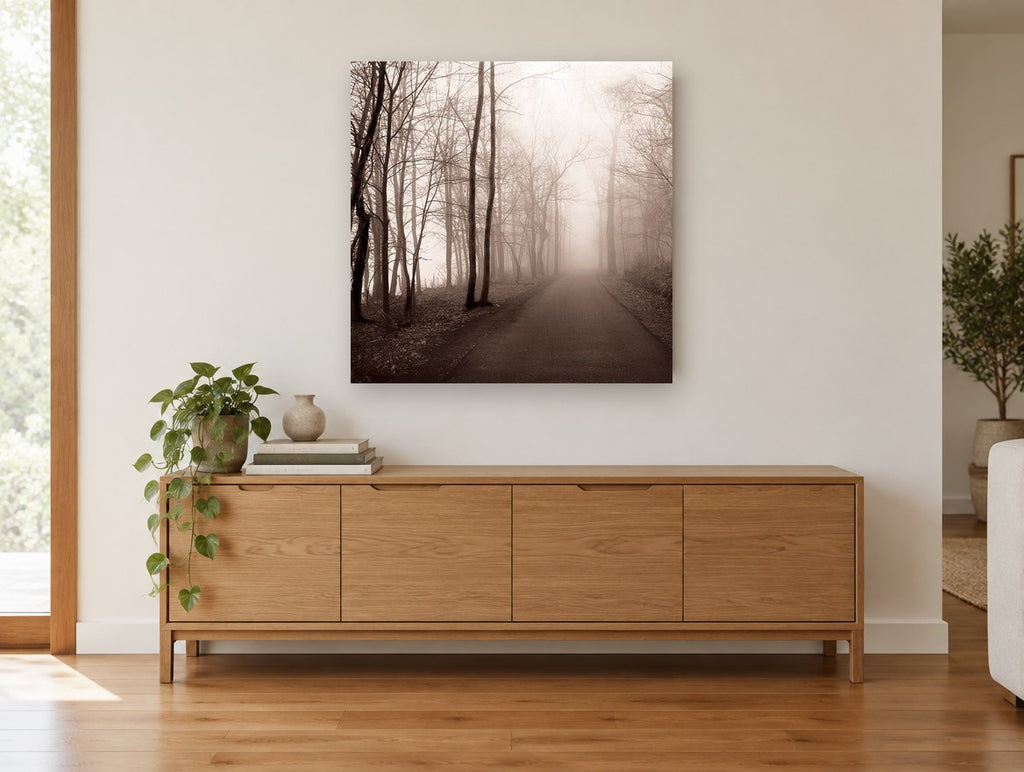 Sepia Fog Lane landscape canvas print on the wall of a living room above a sideboard