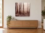 Sepia Winter Woods landscape canvas print on the wall of a living room above a sideboard
