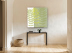 Layered Green Fronds floral canvas print on the wall of a hallway