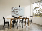 Swallows Among Bare Branches landscape canvas print on the wall of a dining room