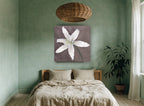 Pale Lily Bloom floral canvas print on the wall of a bedroom
