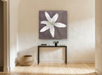 Pale Lily Bloom floral canvas print on the wall of a hallway