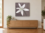 Pale Lily Bloom floral canvas print on the wall of a living room above a sideboard