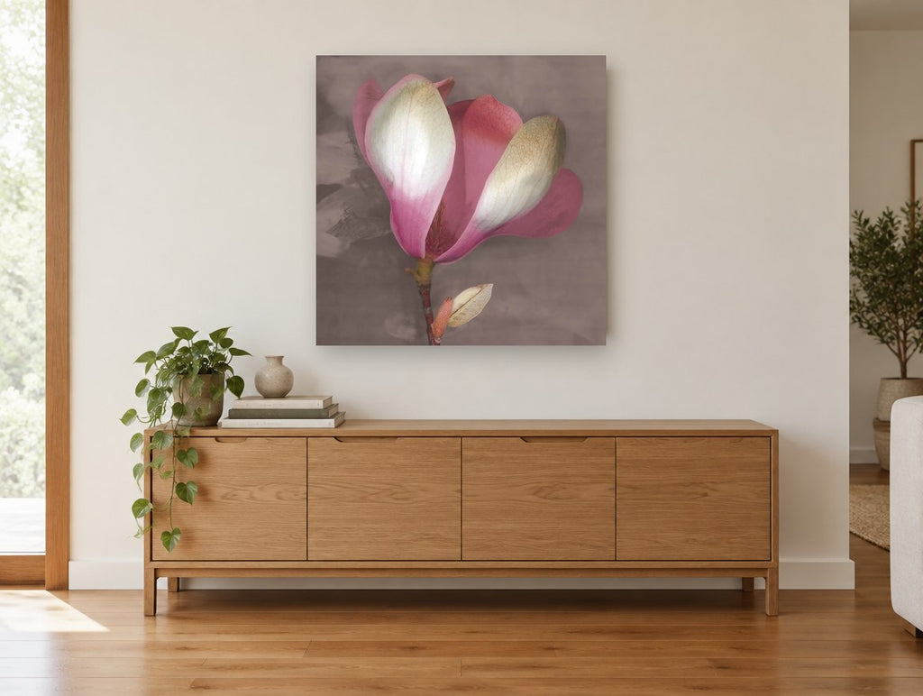 Blushing Magnolia Bloom floral canvas print on the wall of a living room above a sideboard