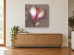 Blushing Magnolia Bloom floral canvas print on the wall of a living room above a sideboard