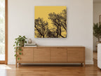 Ochre Branch Silhouettes landscape canvas print on the wall of a living room above a sideboard