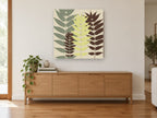 Three Leaf Fronds floral canvas print on the wall of a living room above a sideboard
