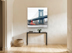Red Tug Under Blue Span city canvas print on the wall of a hallway