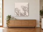 Bare Branch Canopy landscape canvas print on the wall of a living room above a sideboard