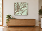 Bare Branches on Sage landscape canvas print on the wall of a living room above a sideboard