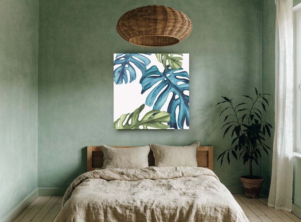 Teal Monstera Drift floral canvas print on the wall of a bedroom