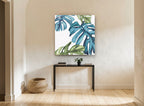 Teal Monstera Drift floral canvas print on the wall of a hallway