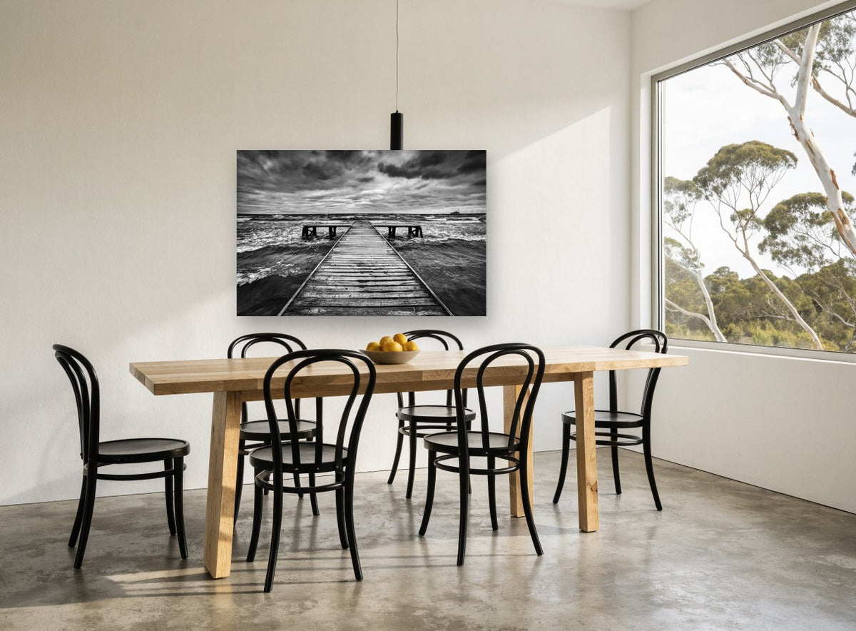 Monochrome Tempest Jetty coastal canvas print on the wall of a dining room