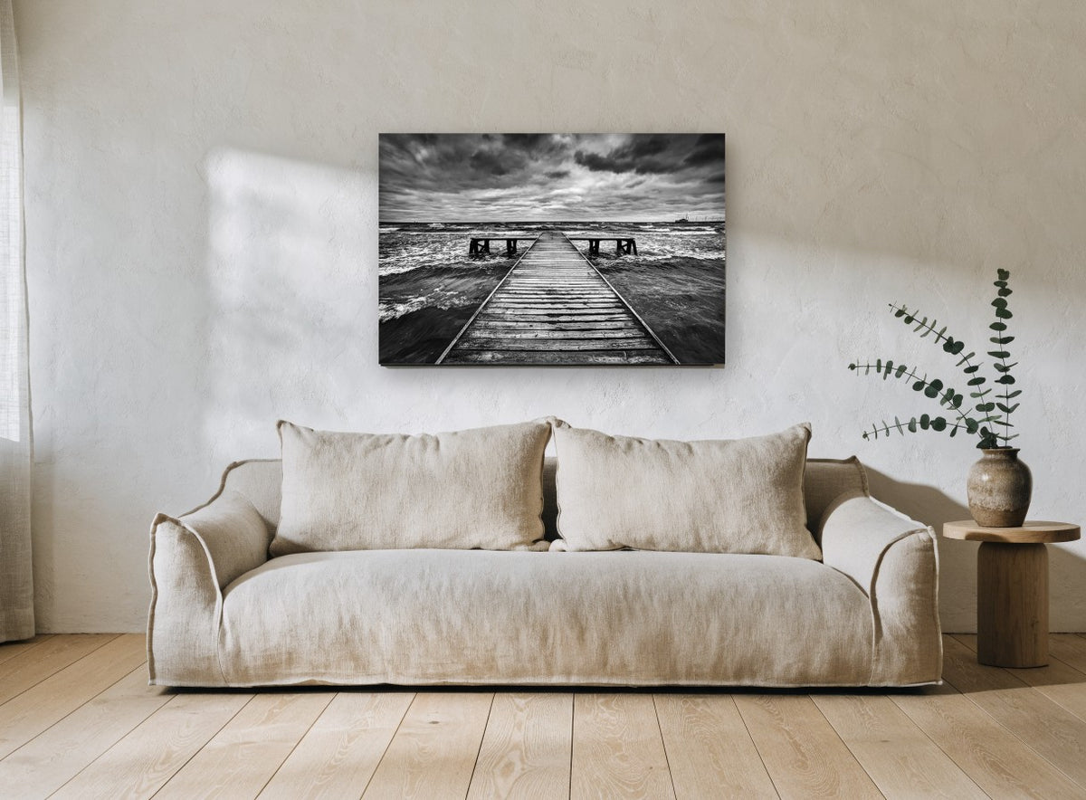 Monochrome Tempest Jetty coastal canvas print on the wall of a living room